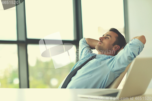 Image of happy young business man at office