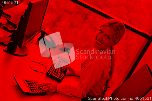 Image of Young pretty business woman with notebook in the office