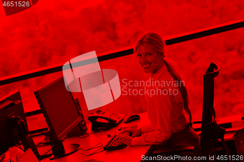 Image of business woman working on her desk in an office