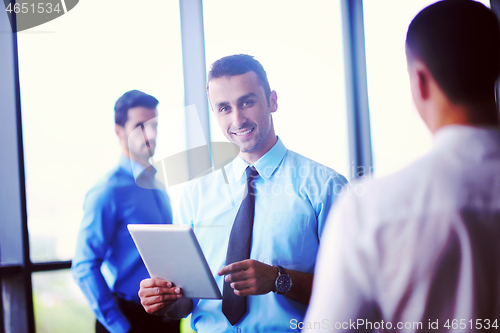 Image of business man using tablet compuer at office