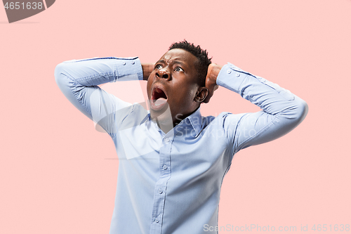 Image of The young emotional angry man screaming on pink studio background