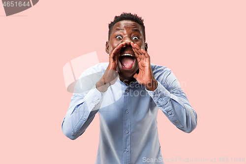 Image of Isolated on pink young casual man shouting at studio