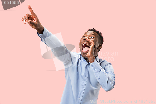 Image of Isolated on pink young casual man shouting at studio