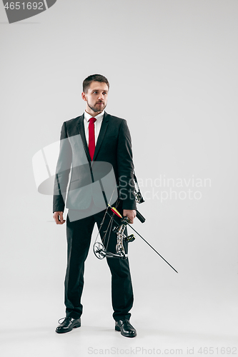 Image of Businessman aiming at target with bow and arrow, isolated on white background