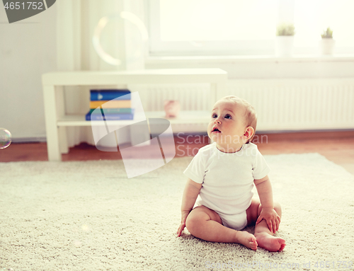 Image of happy baby with soap bubbles at home