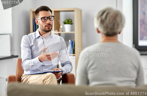 Image of psychologist talking to senior woman patient
