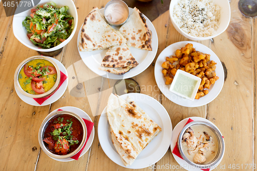 Image of various food on table of indian restaurant