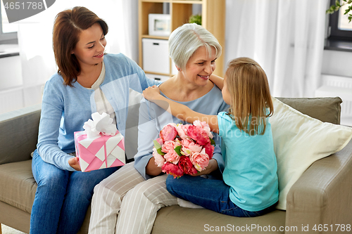 Image of granddaughter hugging and greeting grandmother