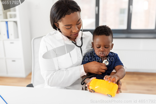 Image of doctor with stethoscope and baby patient at clinic