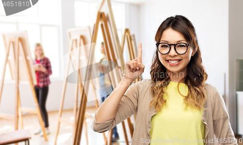 Image of asian woman in glasses or student with finger up