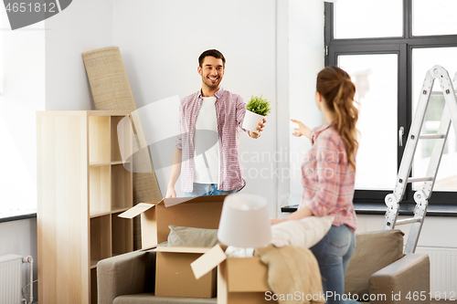 Image of happy couple with stuff moving to new home