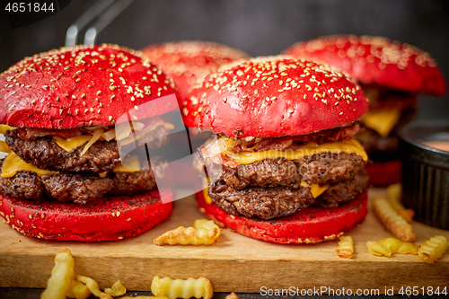 Image of Burgers and french fries on board