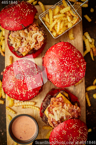 Image of Burgers near sauce and french fries