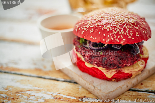 Image of Beetroot burger on shabby table