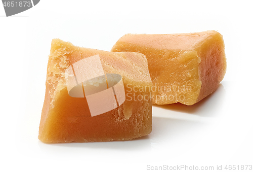 Image of caramel pieces on white background