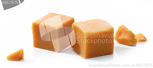 Image of caramel candies on white background