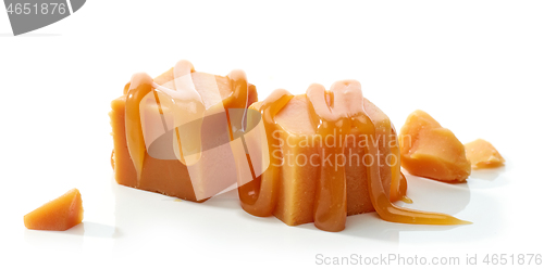 Image of caramel candies with melted caramel sauce