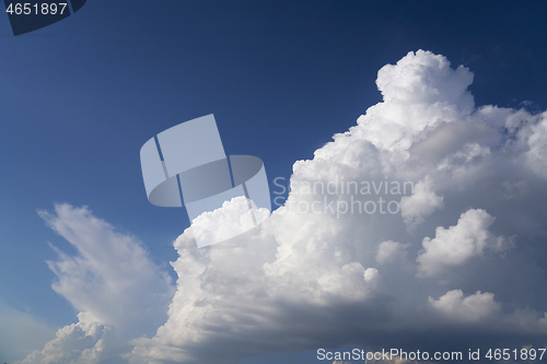 Image of Big white fluffy cloud on blue sky