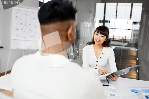 Image of employer having interview with employee at office