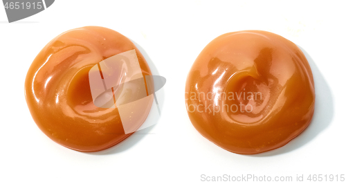 Image of melted caramel on white background