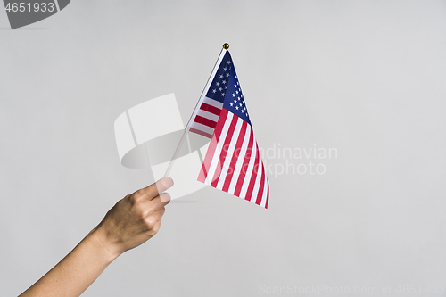 Image of Human hand holding USA flag