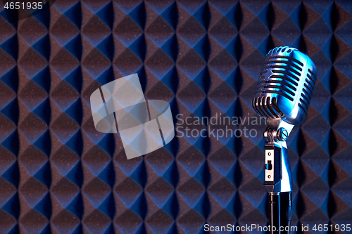 Image of Studio retro condenser microphone on acoustic foam panel