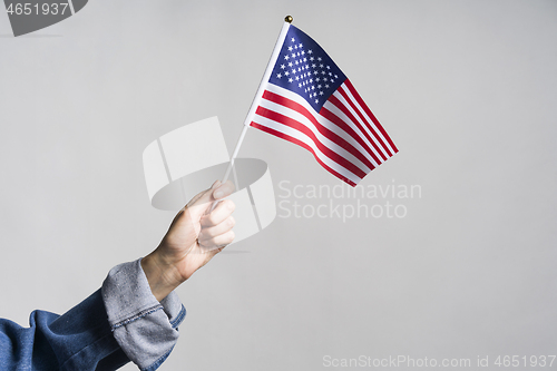 Image of Human hand holding USA flag