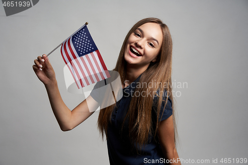 Image of Happy female holding USA flag