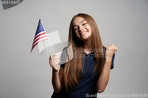 Image of Happy female holding USA flag