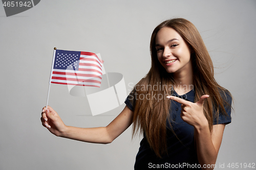 Image of Happy female holding USA flag