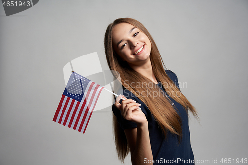 Image of Happy female holding USA flag