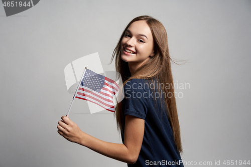 Image of Happy female holding USA flag