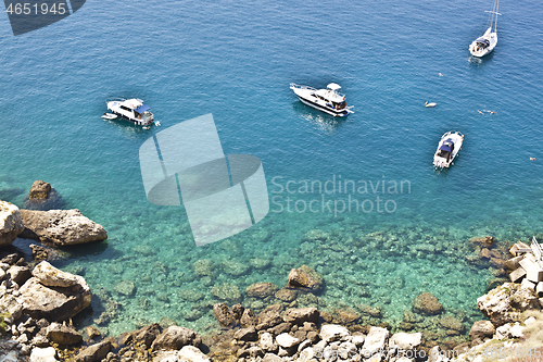 Image of View of the Tremiti Islands. Boats near a rock stone coast.