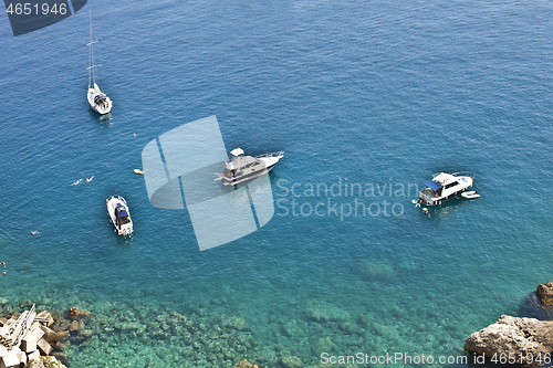 Image of View of the Tremiti Islands. Boats near a rock stone coast.