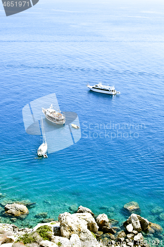 Image of View of the Tremiti Islands. Boats near a rock stone coast.