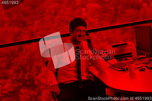 Image of happy young business man at office
