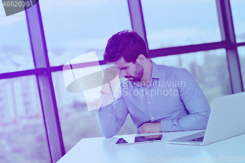Image of happy young business man at office