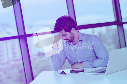 Image of happy young business man at office