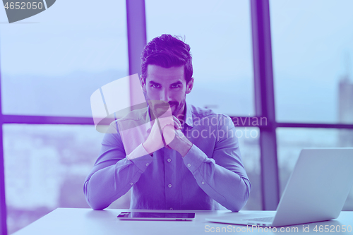 Image of happy young business man at office