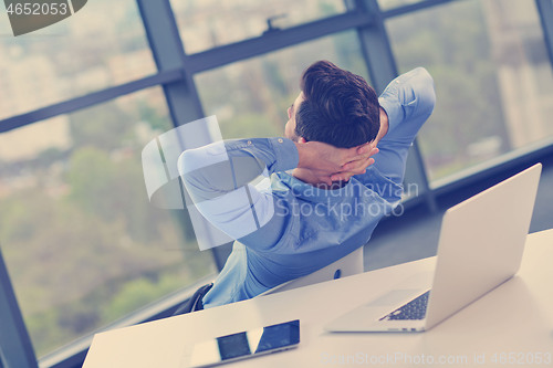 Image of happy young business man at office