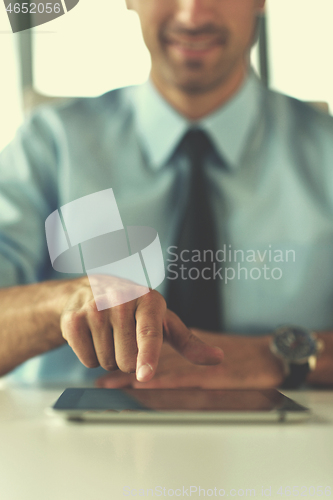 Image of business man using tablet compuer at office