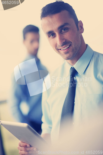 Image of business man using tablet compuer at office