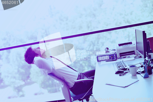 Image of happy young business man at office