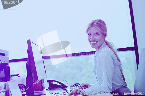 Image of business woman working on her desk in an office