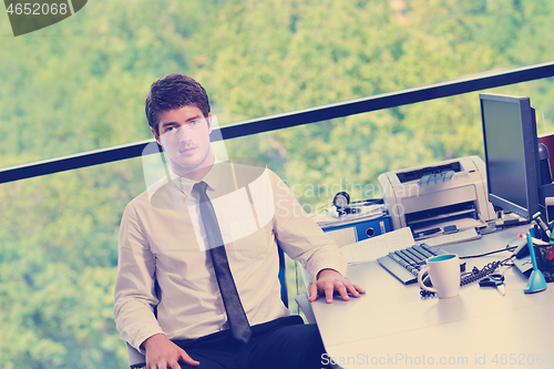 Image of happy young business man at office