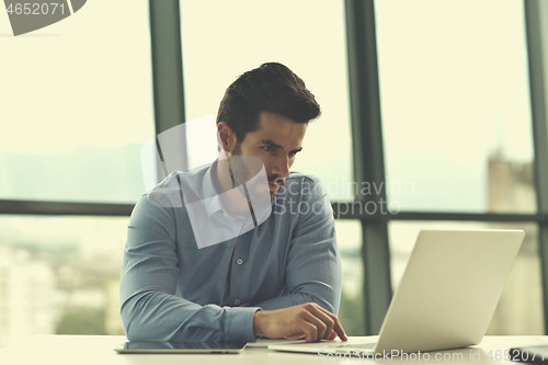 Image of happy young business man at office