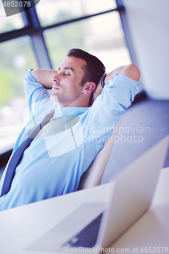 Image of happy young business man at office