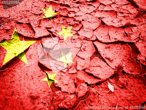 Image of China flag on dry cracked earth