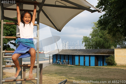 Image of Portrait of a young cute girl on a playing field