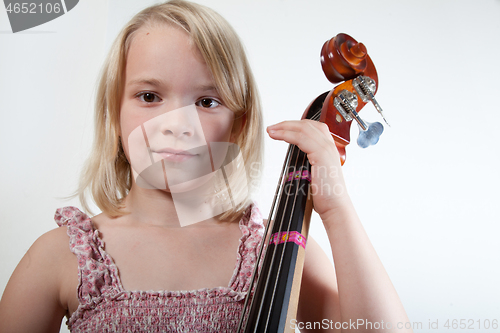 Image of Portrait of a young teenager girl in studio with a cello